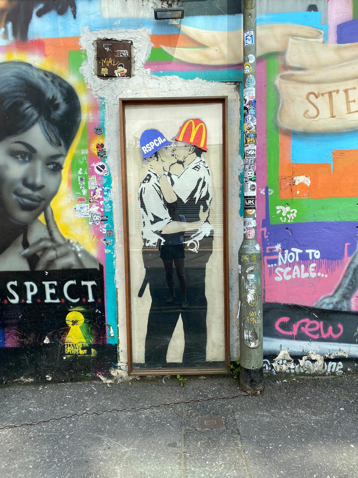Banksy's Copper Kissing has stickers on the policemen's helmets, depicting one as the RSPCA and one as McDonald's