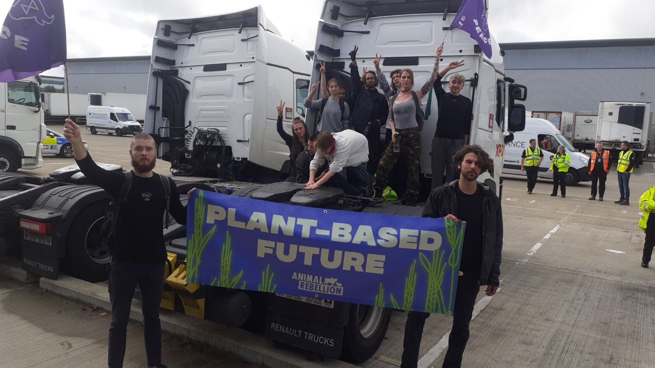 Protestors at Hatfield Arla holding up a banner reading 'plant-based future'